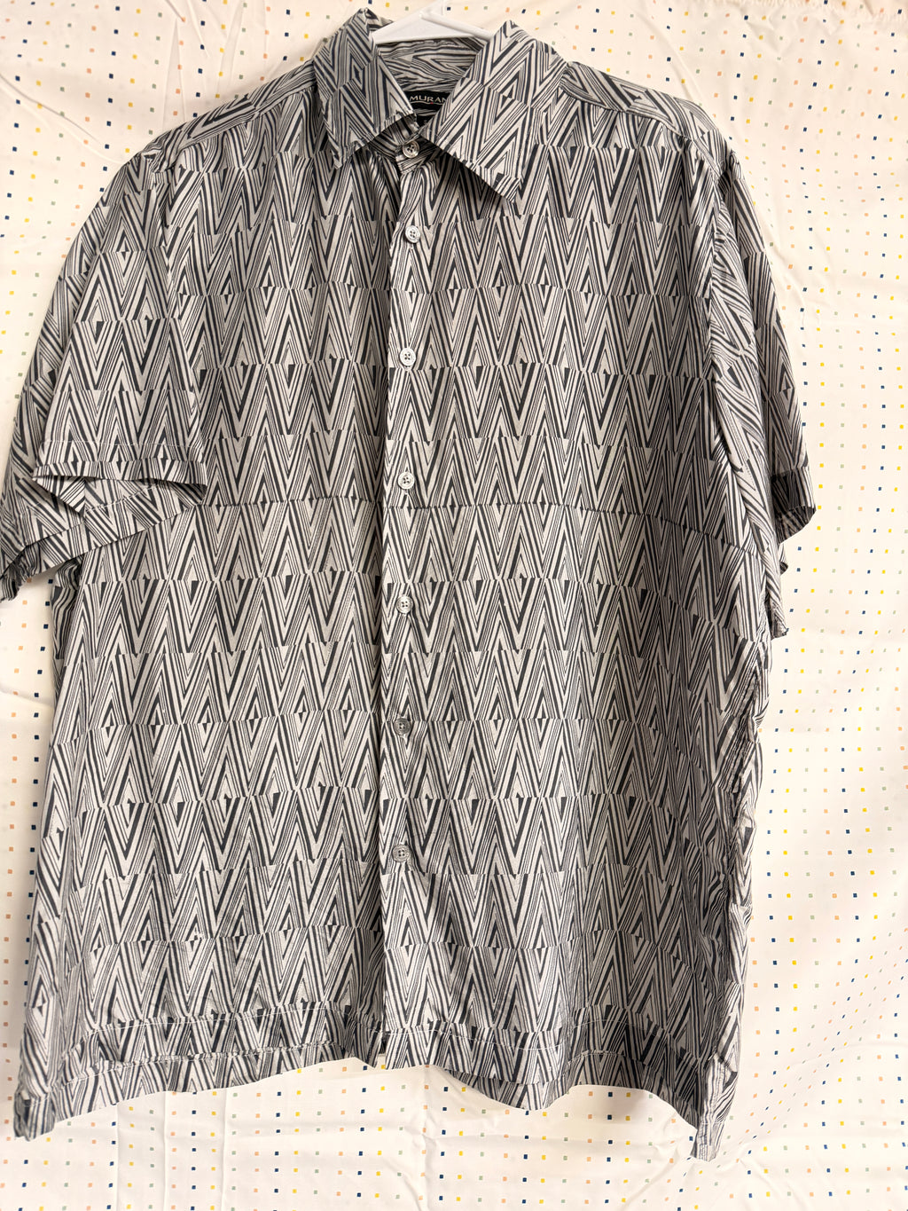 Stylish vintage Murano 100% silk button-front shirt featuring a bold black and white geometric pattern throughout. Lightweight and breathable with a relaxed