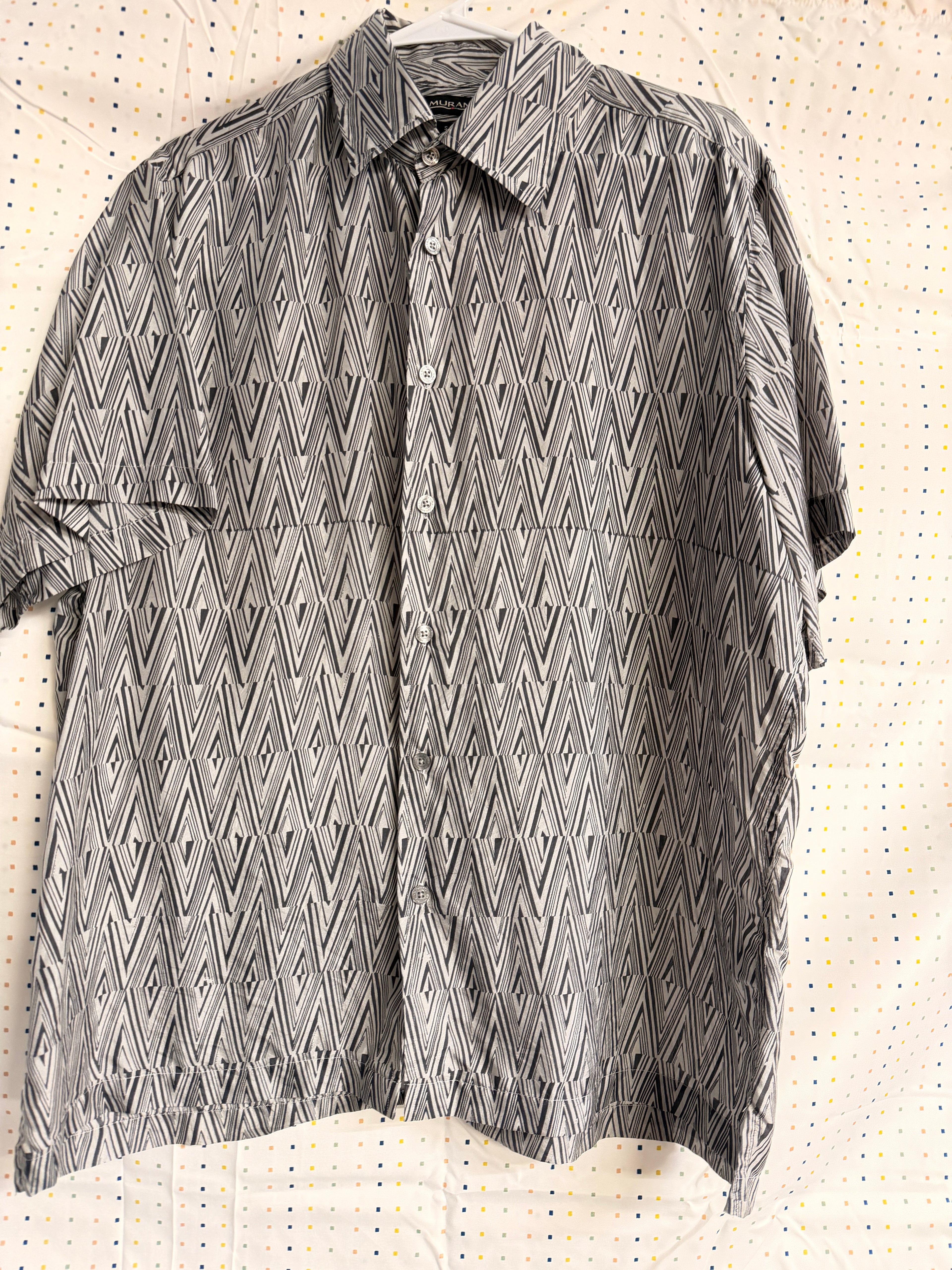 Stylish vintage Murano 100% silk button-front shirt featuring a bold black and white geometric pattern throughout. Lightweight and breathable with a relaxed