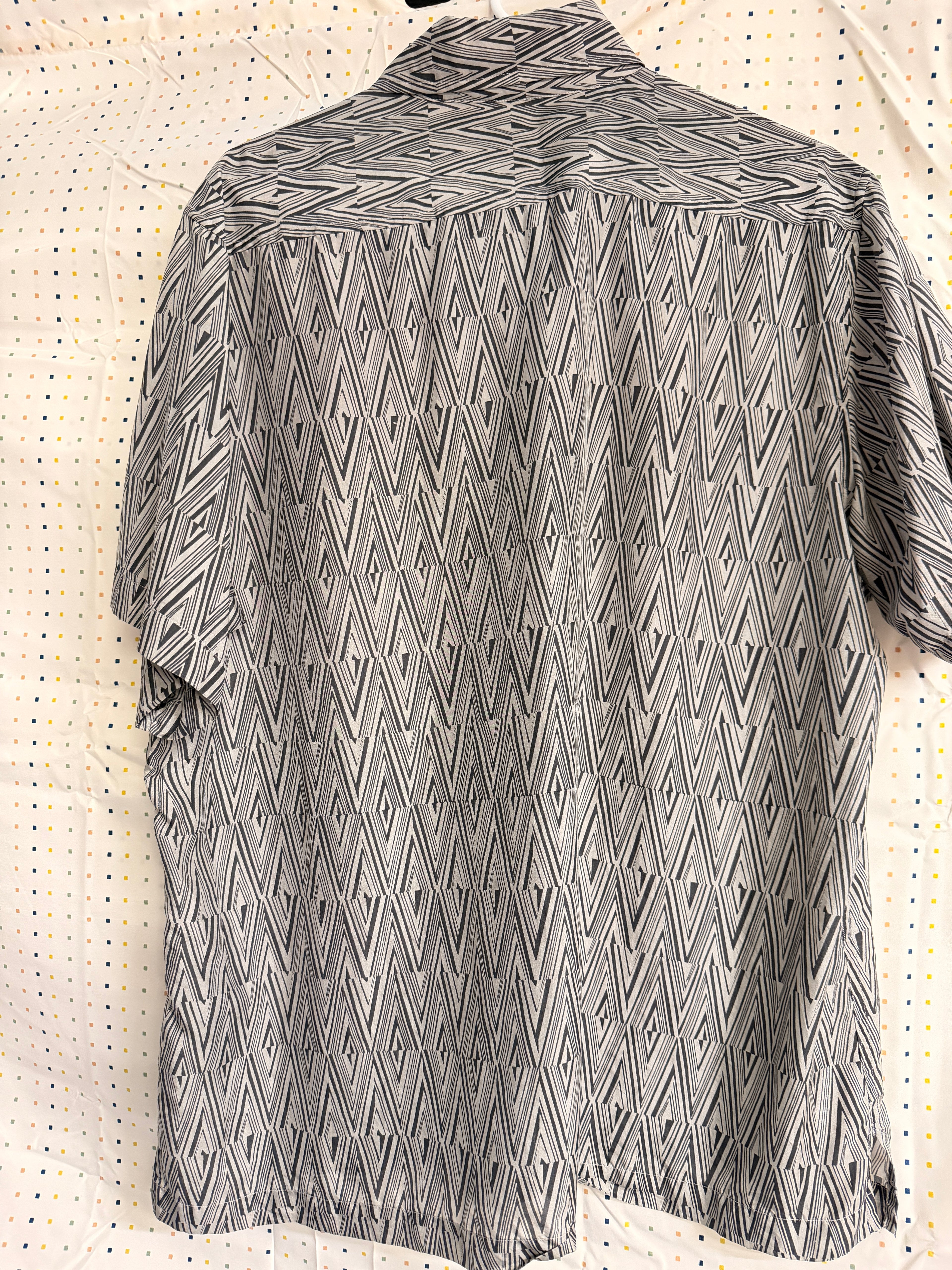 Stylish vintage Murano 100% silk button-front shirt featuring a bold black and white geometric pattern throughout. Lightweight and breathable with a relaxed