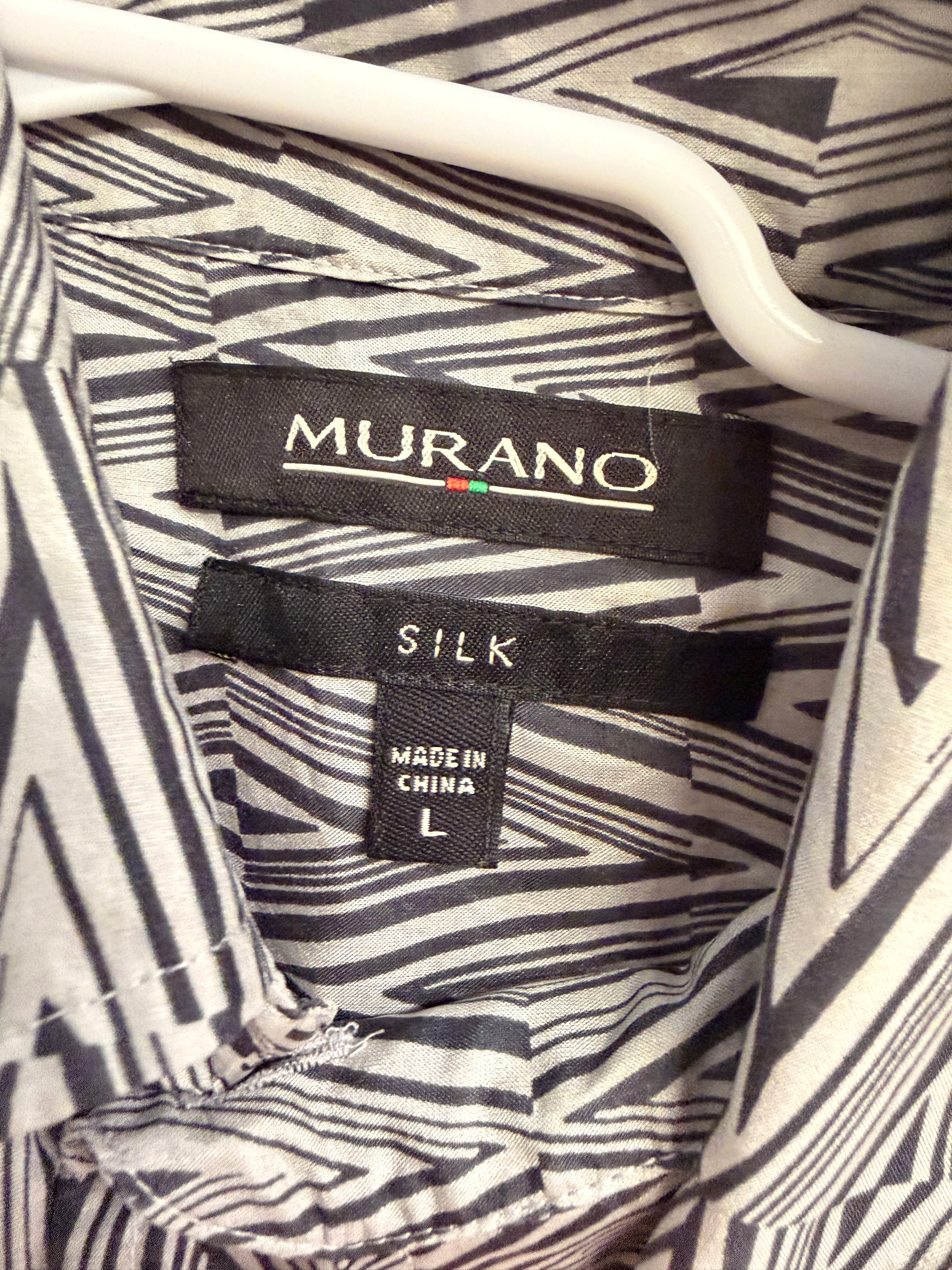 Stylish vintage Murano 100% silk button-front shirt featuring a bold black and white geometric pattern throughout. Lightweight and breathable with a relaxed